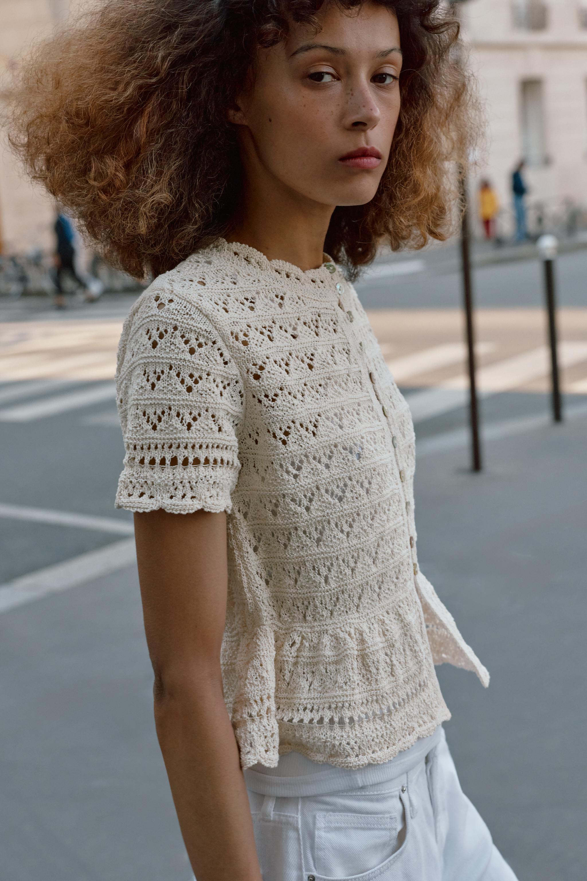 GILET EN MAILLE POINTELLE À MANCHES COURTES